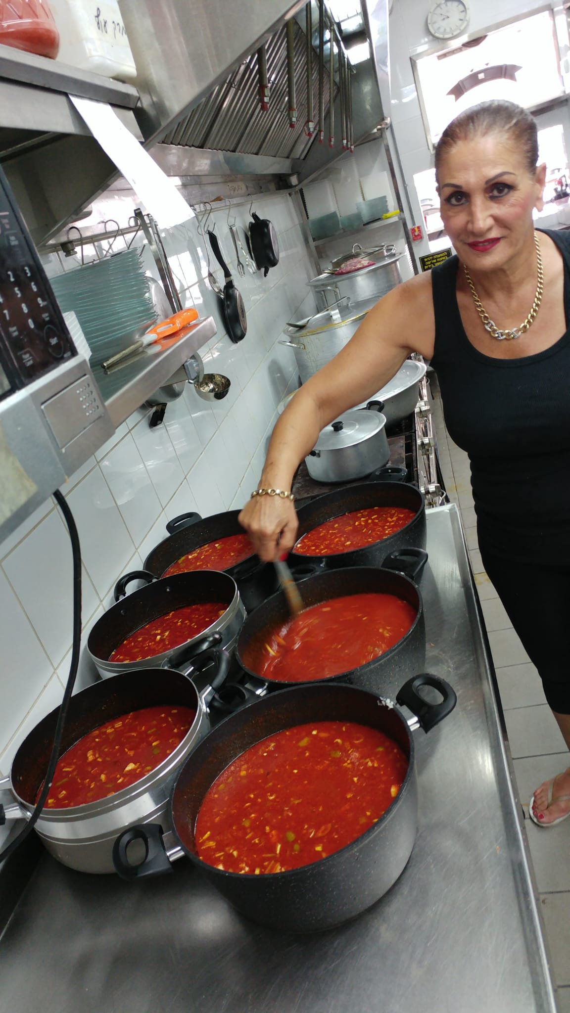 שושי מבשלת לצד הסירים במטבח